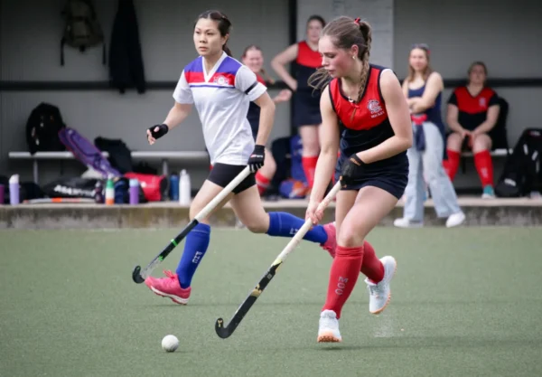 Women playing hockey