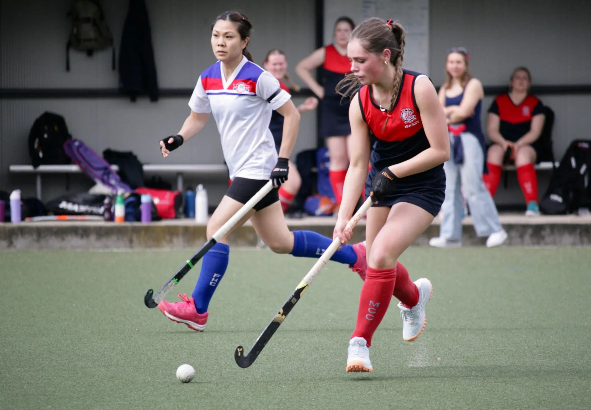 Women playing hockey
