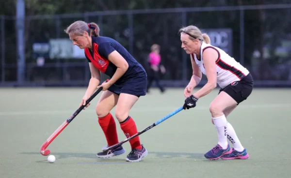 Women playing hockey